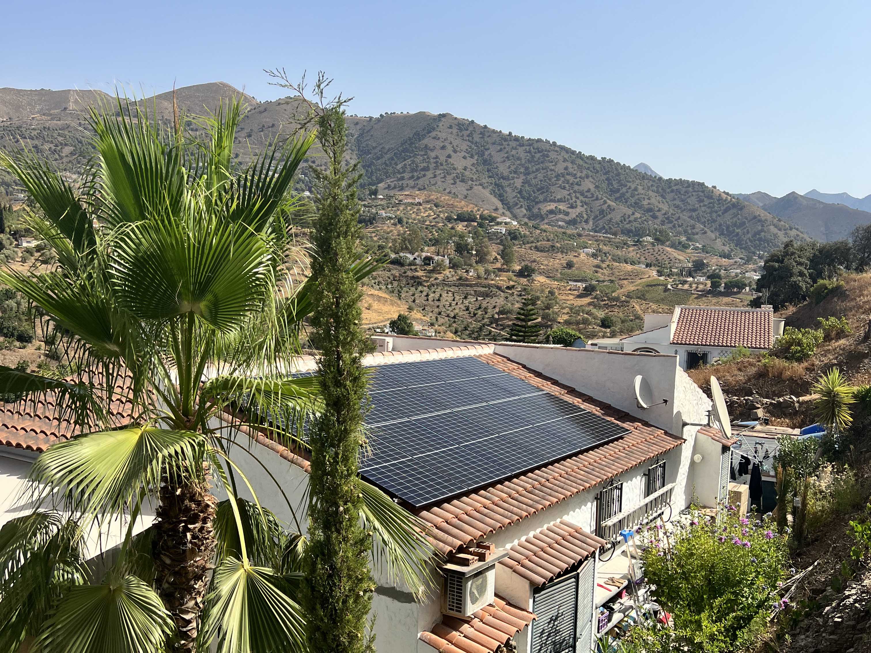 Solar installation team on a Spanish villa roof